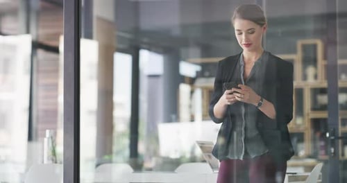 Young Woman Texting and Talking on Phone at Work