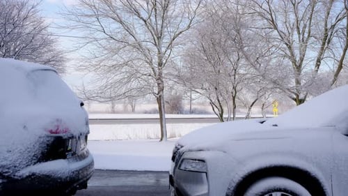 Schneebedeckte Autos vor dem Hintergründe der stark befahrenen Autobahn an einem sonnigen Wintertag Wintertage in einem
