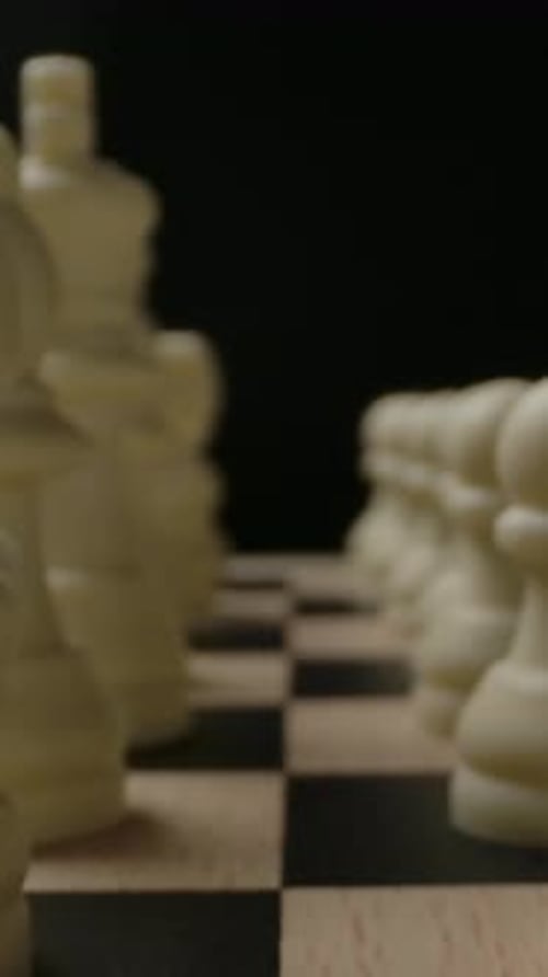 Vertical of White Chess Pieces in Start Row Position Ready to Game