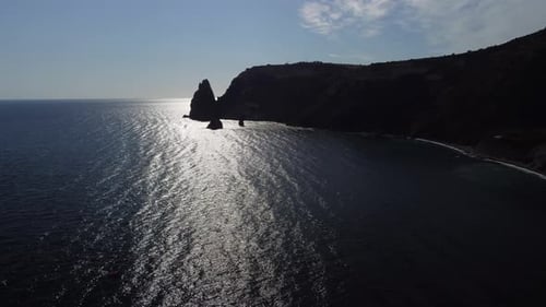Aerial View of Rocky Coastline and Calm Ocean