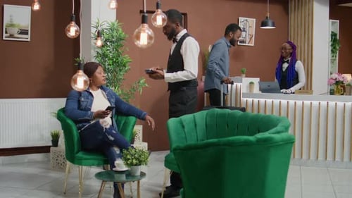 Woman Paying at Hotel Lobby with Mobile Phone