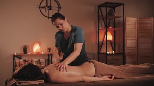 Master makes a professional massage, spa salon. Relaxing and healthing procedure.