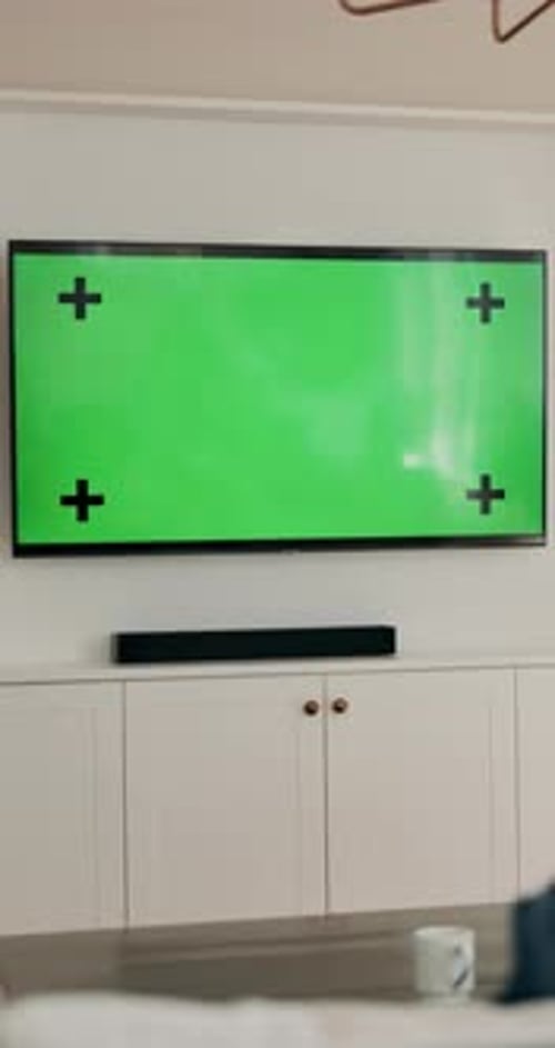 Home, movies and tv in living room with green screen, tracking marker or relax with broadcast