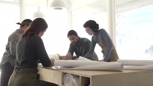 Architects Discussing Plans in Creative Studio Adult