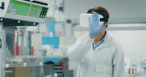 Portrait of futuristic researcher using the augmented reality vr glasses with hologram graphics fo