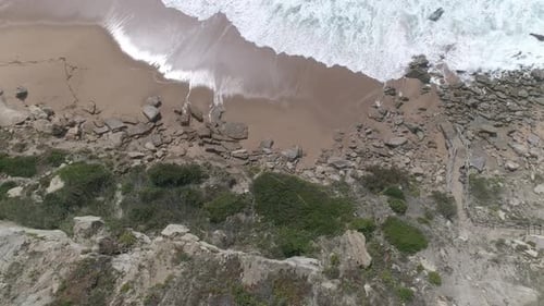 Top Down cliffs and coast line with waves breaking