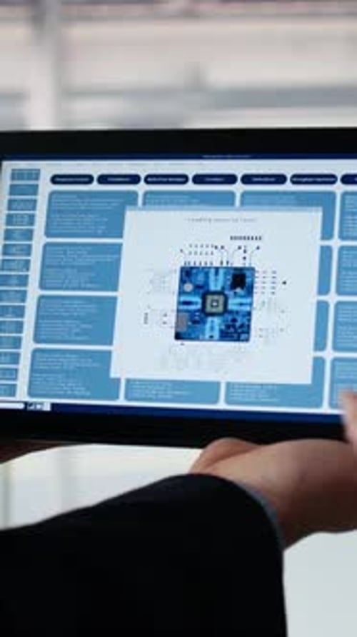 Vertical Video Close Up of Employee Examining Microchip Circuit Layout with Tablet