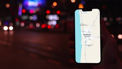 Hand Holding Cell Phone with Map at Night