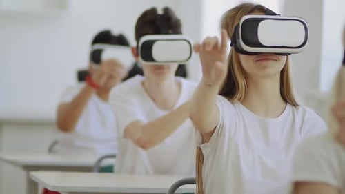 Teens Using Virtual Reality Headsets in Modern Classroom