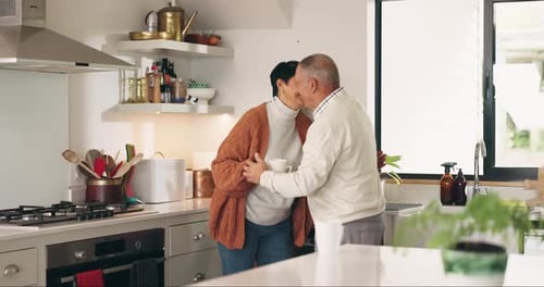 Loving Senior Couple Embrace in Bright Kitchen