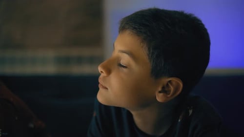 Intimate Close Up of a Young Boy in Dark