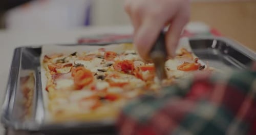 Woman Cutting Freshly Baked Italian Pizza Into Slices