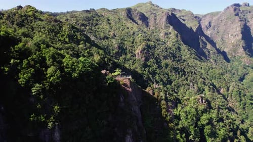 Aerial panorama of tourist sightseeing rocky mountain range on a viewpoint platform, Madeira