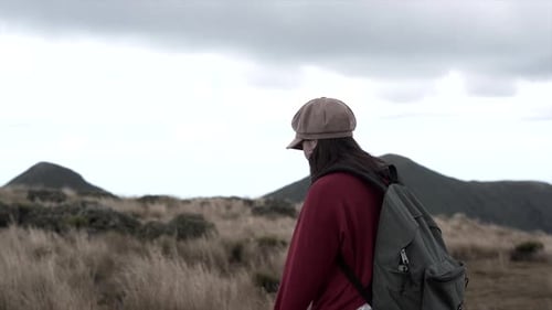 Woman Walking with Cap and Backpack on Mt