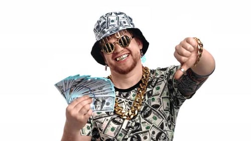 Extravagant Young Man with Bundle of Dollars Showing Thumb Down Crazy Rich Person Studio Portrait