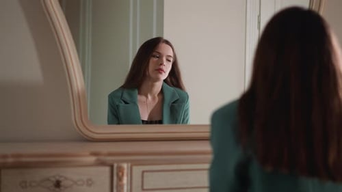 Woman Gazing at Reflection in Vintage Mirror
