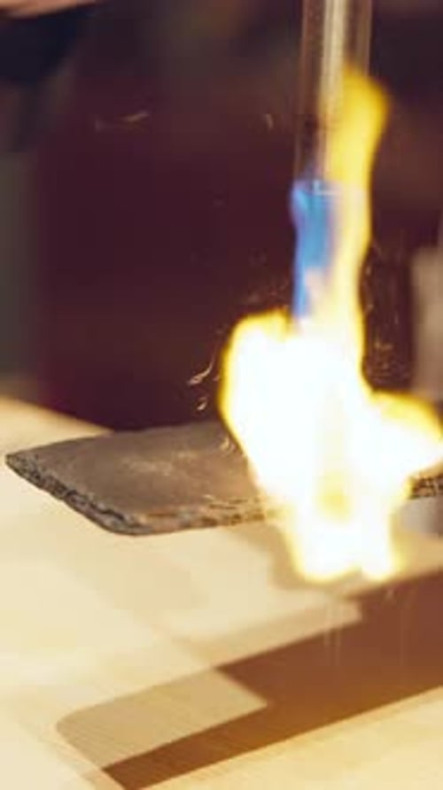 Blowtorch Cooking Fish in Close Up Shot