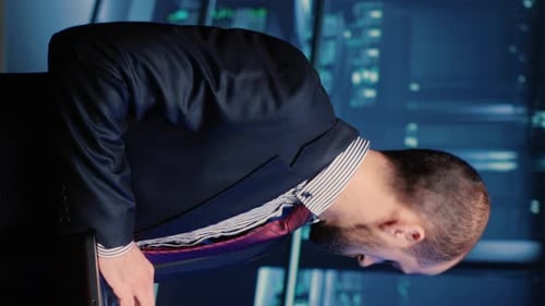 Man In Suit Using Tablet At Night