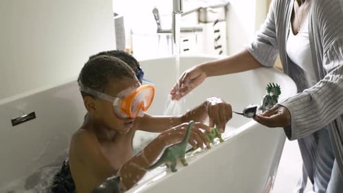 Children Play with Dinosaur Toys in the Bathtub