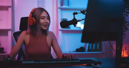 Woman Gaming Enthusiastically in Neon Lit Room
