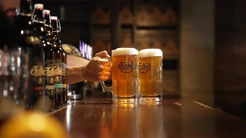 The Bartender Puts Down a Glass of Cold Beer