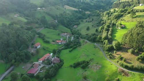 flight in a rural area making a turn with the gimbal seeing rural houses in a village surrounded by