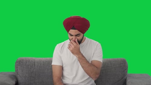 Sikh Indian man suffering from cold and cough Green screen