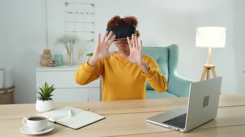 Woman with VR Headset at Table