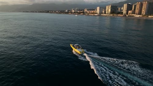 Speedboat Cruising Along Coastline on Sunny Day