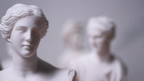 Statue of Greek Goddess Aphrodite with others out of focus - Right to Left