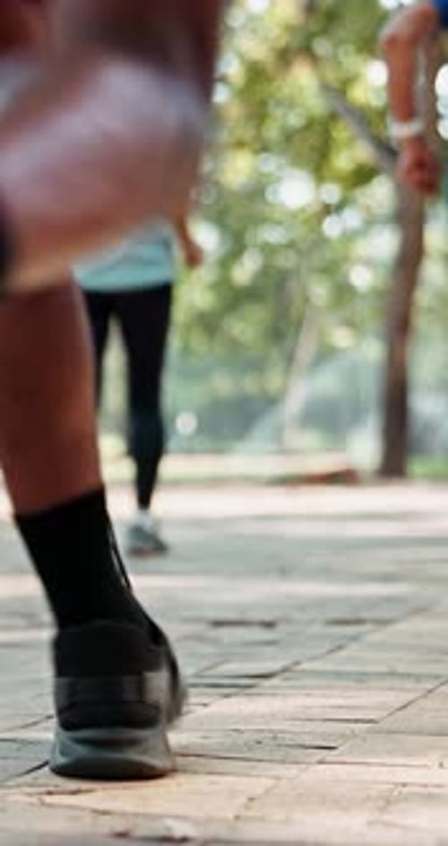 Running, marathon and feet with people in city for sports, fitness challenge and workout