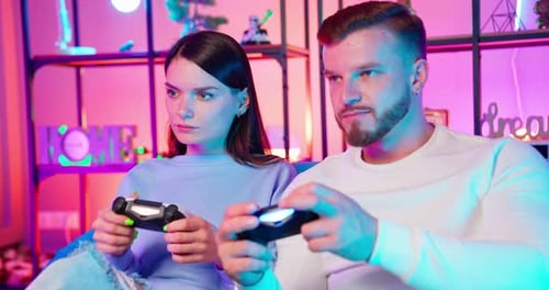 Young Couple Playing Video Games Together at Home