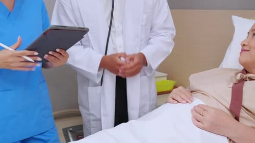 Doctor and Nurse Visiting Senior Patient in Hospital