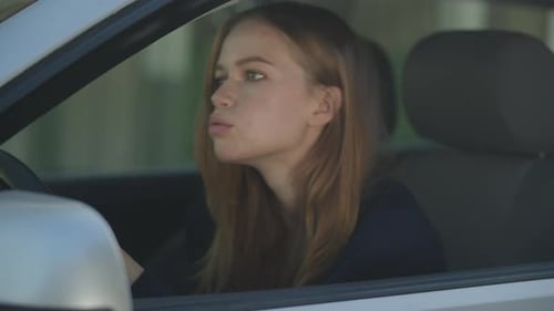 Young Woman Using Smartphone in Car