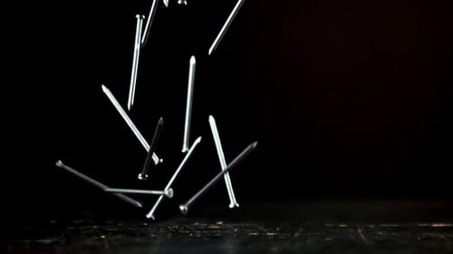 Super Slow Motion a Bunch of Nails Fall on the Table