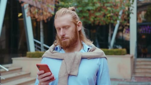 Blond Haired Man Using Cell Phone Outdoors