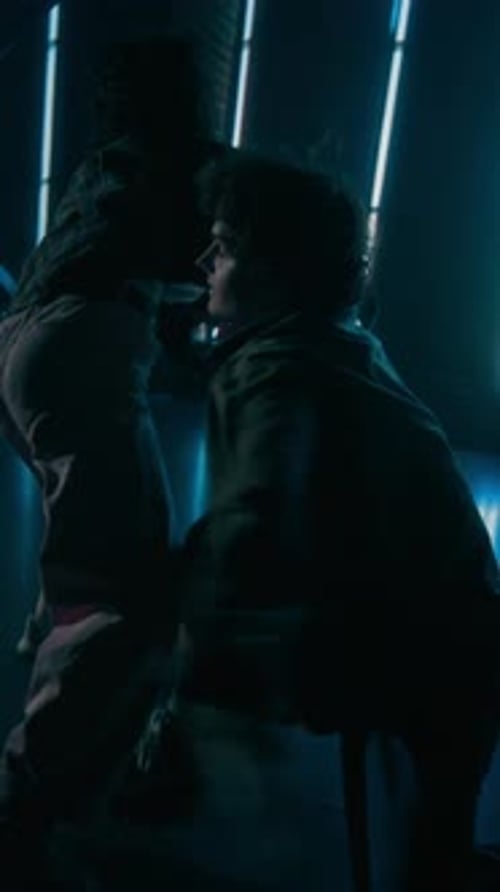 Couple of Dancers Performing Choreography in Dark Space Vertical