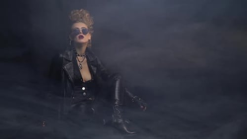 Stylish Woman Posing in Leather Outfit in Smoky Setting