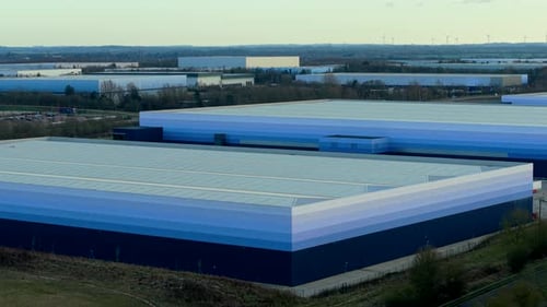 Aerial View of Multiple Warehouse Buildings Operating Logistics Infrastructure Within Industrial