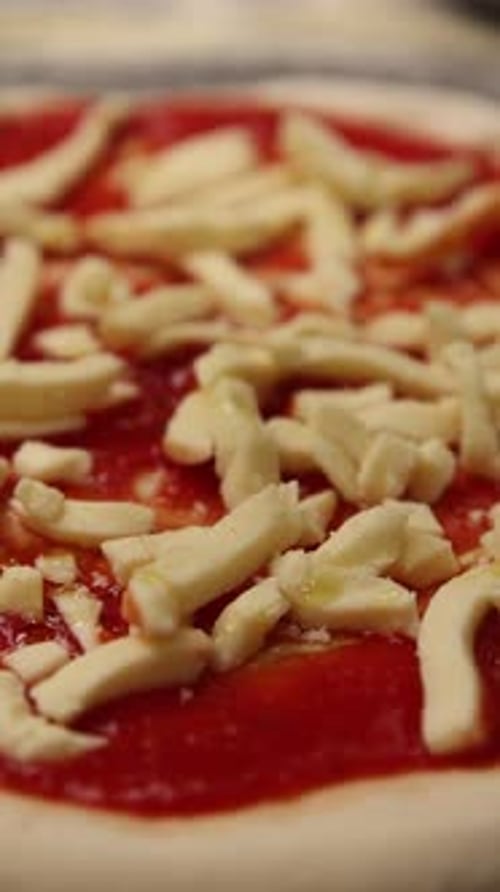 The chef makes delicious pizza in a professional kitchen.