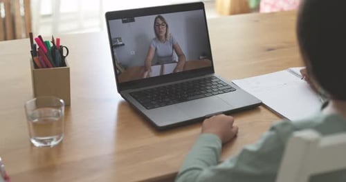 Teenager girl using laptop for tutoring lessons at home - Back to school