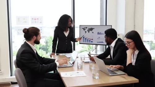 Business Meeting with Diverse Team Discussing Data and Reports