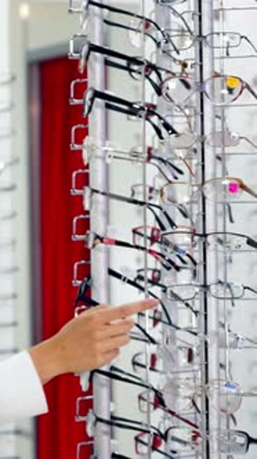 Side view of a female buyer in optical shop.