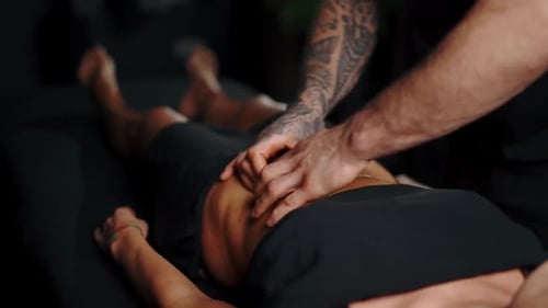Massage Therapist Working on Woman's Back Muscles