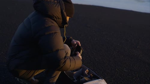 A Man Fixing His Drone In Reynisfjara Beach