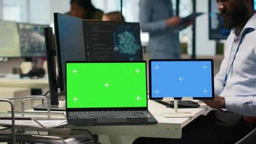 Software Developer Using AI on Isolated Screen Laptop and Tablet