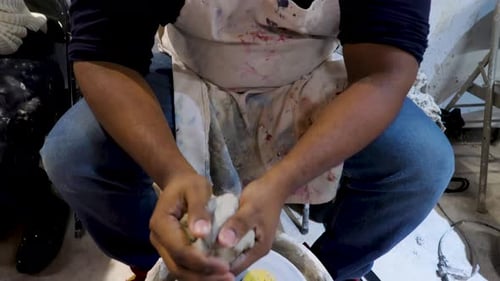 Man Creates Pottery With Clay in Studio