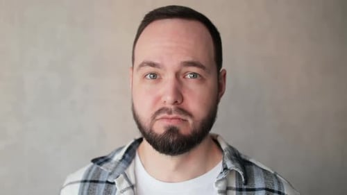 Sad and Depressed Young Man Preparing to Cry Looking at Camera