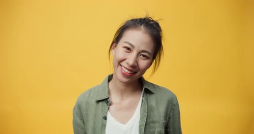 lady stand on isolate yellow empty space background looking at camera with toothy smile enjoy laugh.