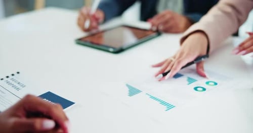 Business Meeting with Charts and Technology